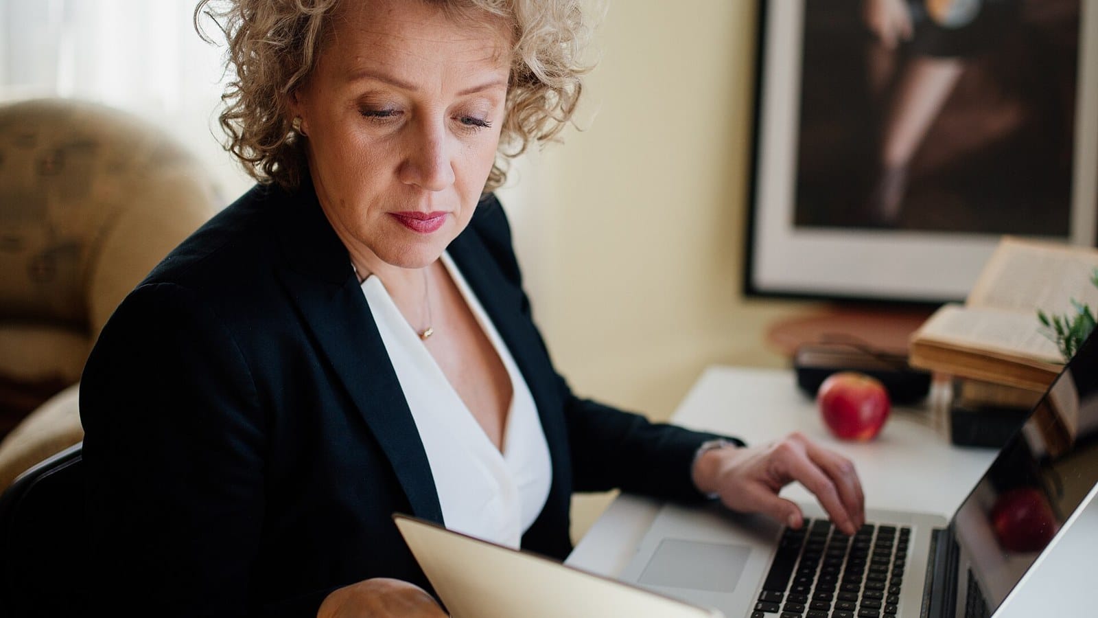 Professionnelle travaillant sur ordinateur pour illustrer la dématérialisation documentaire en entreprise